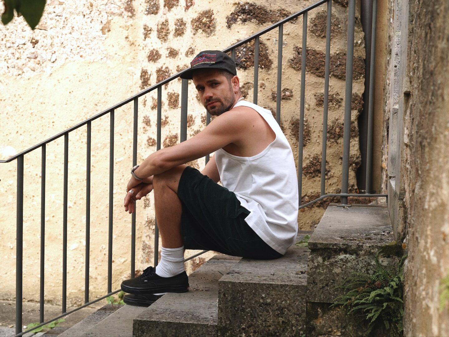 débardeur oversize de la collaboration entre Maison Cornichon et Borasification, porté avec une casquette d'un combat de tyson et short borali en velours vert et vans authentic