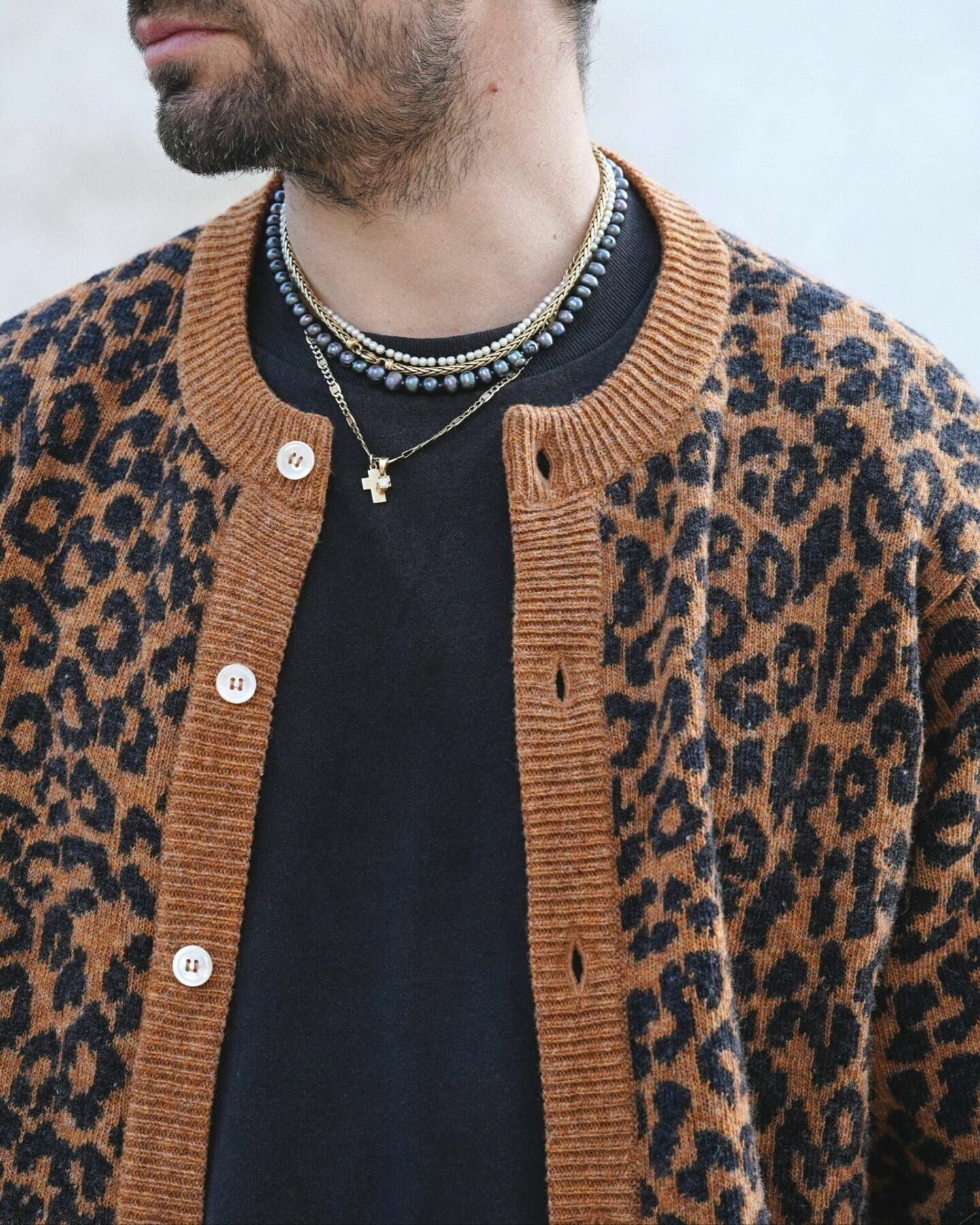 chaine &agrave; maille palmier en or 18 carats et maille figaro ajour&eacute;e port&eacute;es avec un collier en perles de nacre noir &agrave; reflet violet